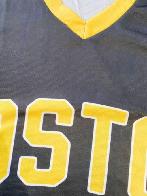 Happy Gilmore inspired black and yellow hockey jersey featuring number 18 and Boston text close up